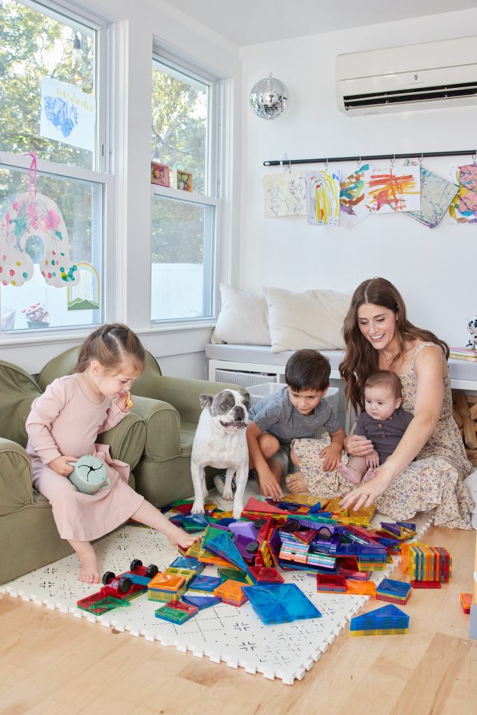 Mom and kids playing in playroom with magnetic tiles.