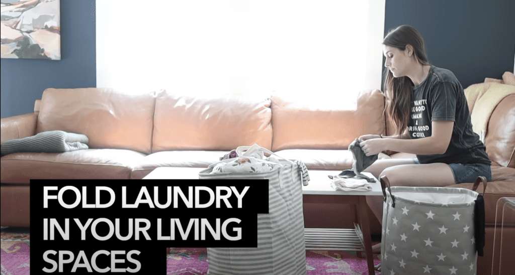 Folding laundry in living room. 