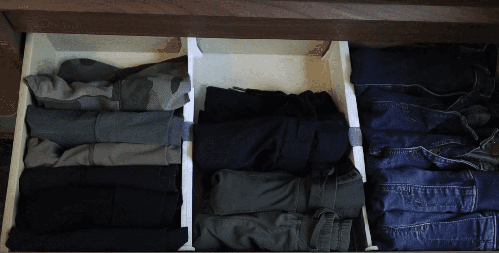 File folding pants in a dresser drawer.