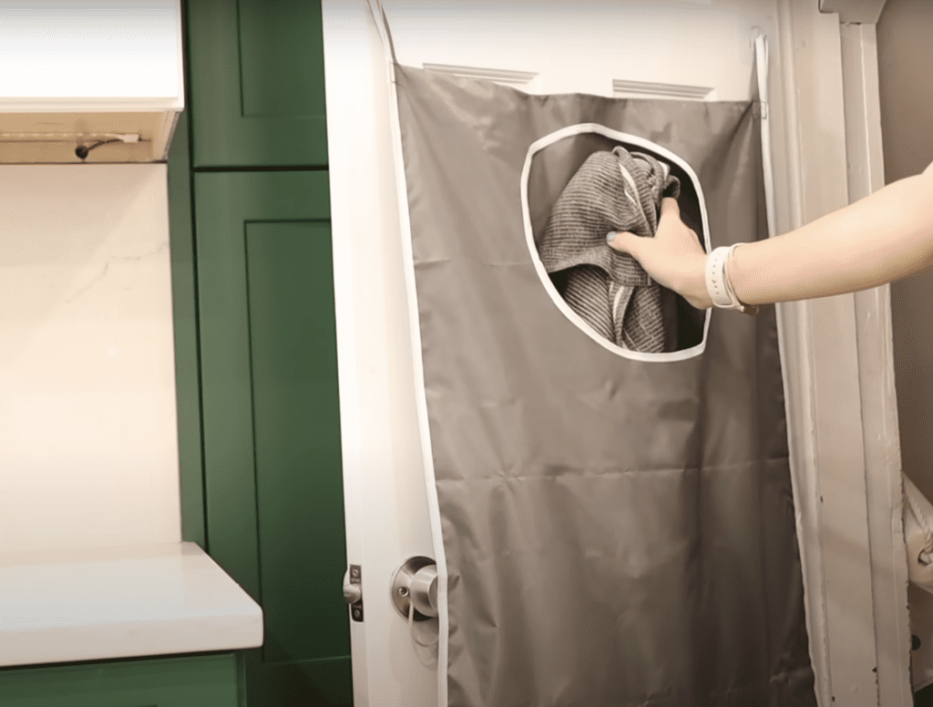 Throwing towel in over-the-door laundry hamper. Over the door hamper in kitchen.